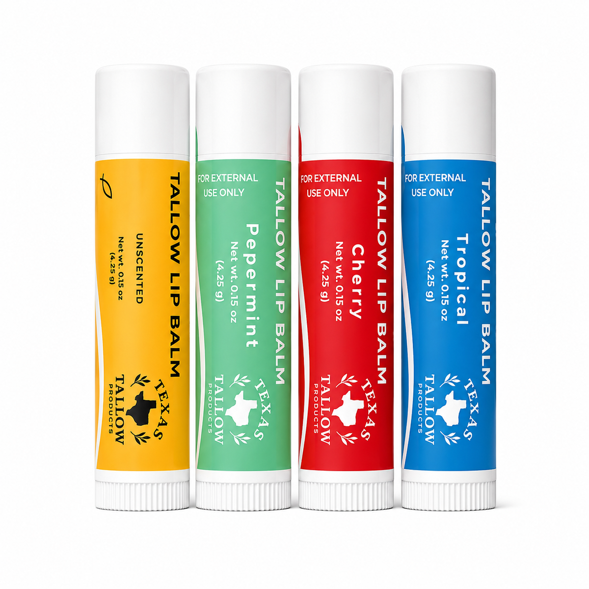Four Tallow Lip Balm tubes standing upright on a white background, each with a different color label: yellow, mint green, red, and blue. The labels show the Texas-shaped Tallow logo and names including Unbleached, Peppermint, Cherry, and Tropical.